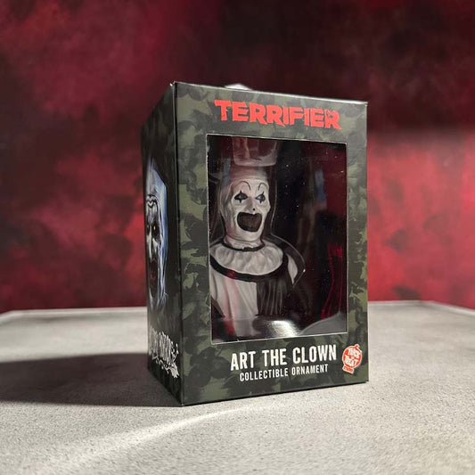 A resin ornament of Art the Clown from the horror movie 'Terrifier', packaged in a collector's window box.