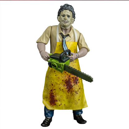 Action figure of Leatherface in yellow apron holding a chainsaw on a white background from Texas Chainsaw Massacre